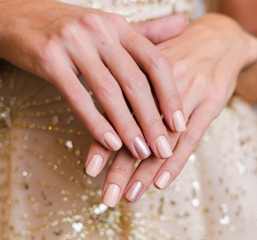 Female hands with christmas new year nail design nude beige nail polish manicure