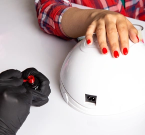 Front view young female manicure with black gloves doing manicure white