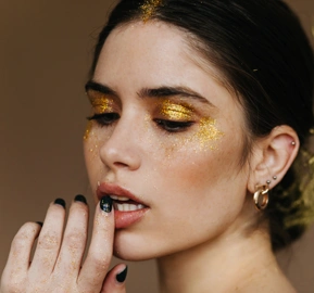 White lady with golden makeup stunning young woman preparing party
